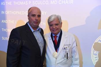 Andreas Dracopoulos, President of the Stavros Foundation standing with a man and being photographed